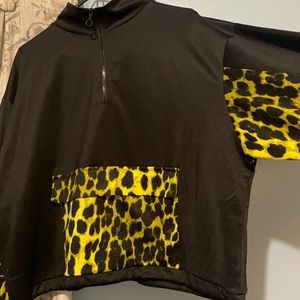 Fashions a cropped sweater with storage pocket